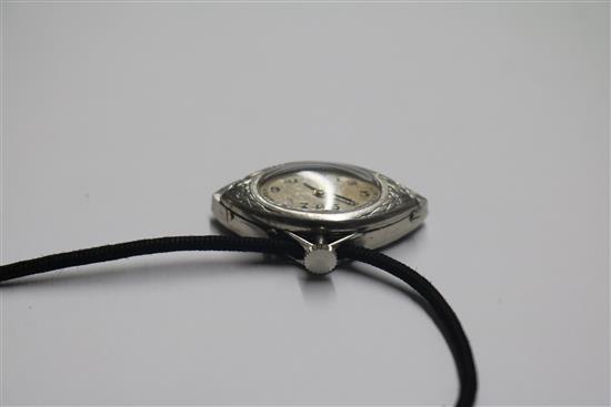 An Art Deco style white metal, diamond and black onyx set fan shaped pendant watch, on a fabric necklace, watch 30mm.